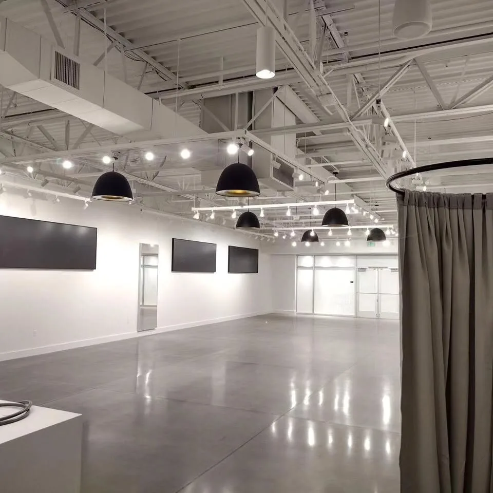 Empty retail showroom with pendant and track lighting installation